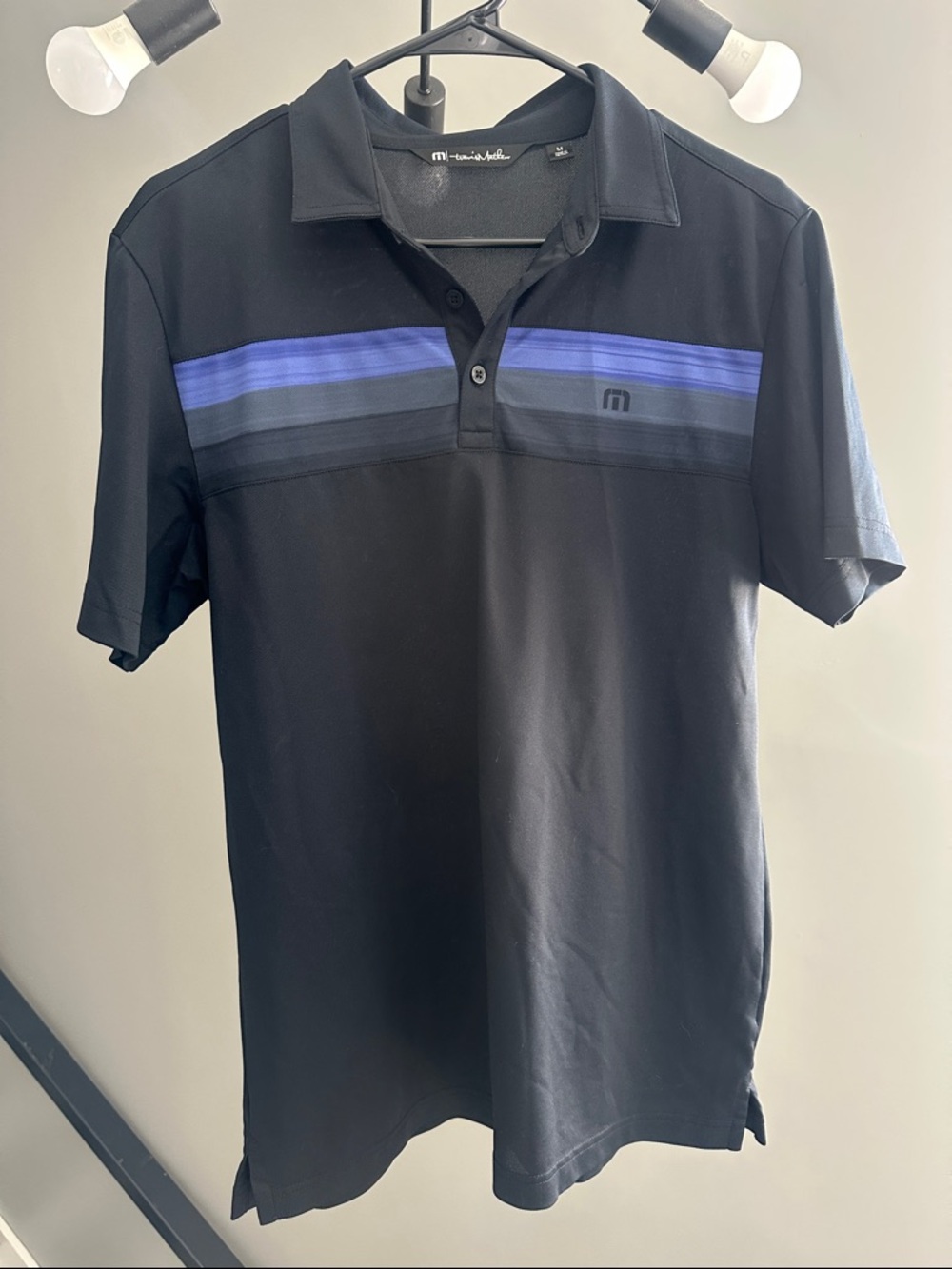 Travis Mathew Black Polo with Blue Stripe Detail